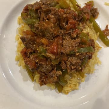 Braised beef and peppers over rice